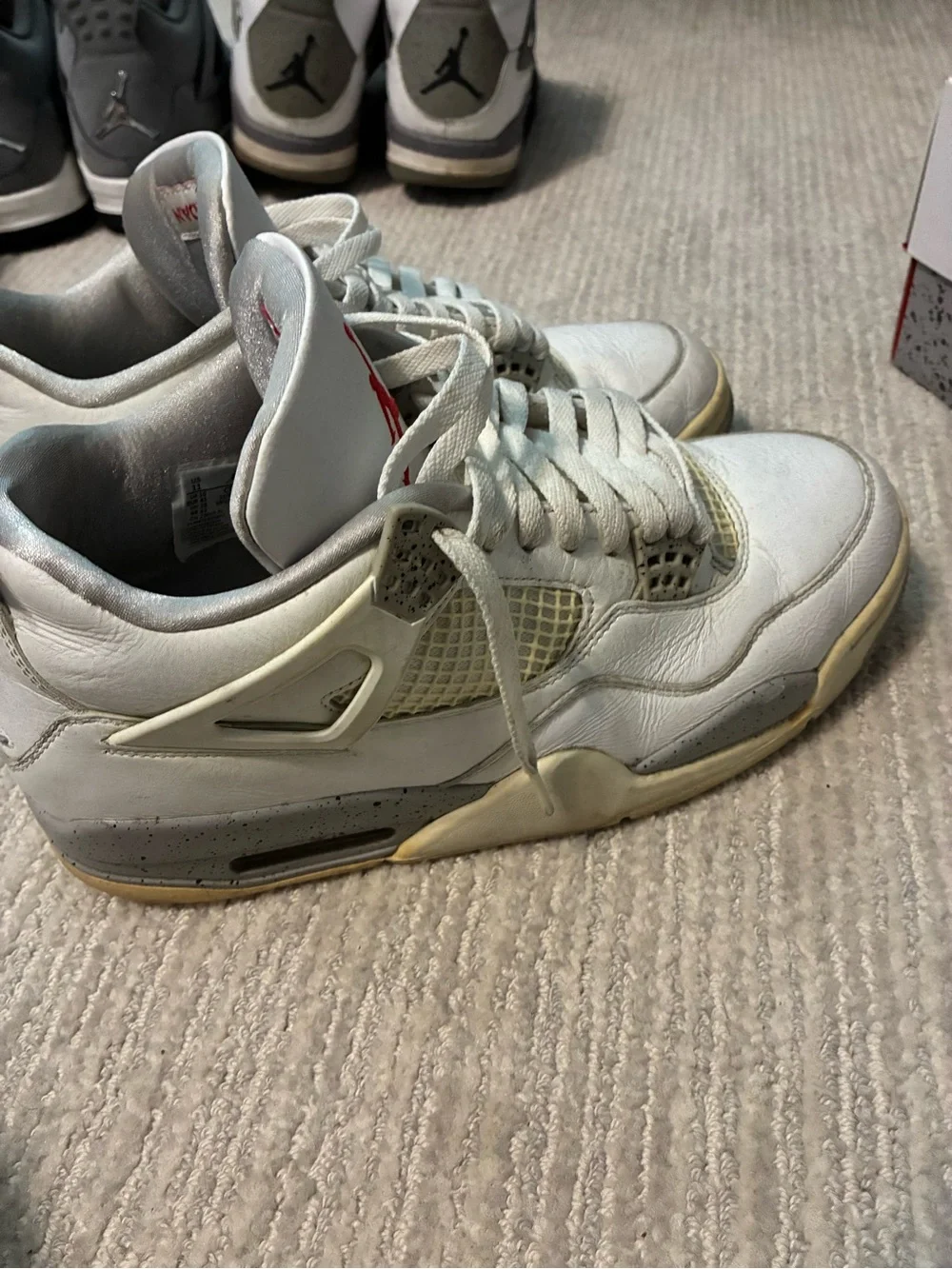 Jordan’s Nike White & Red Air Jordan 4 Retro Sneakers